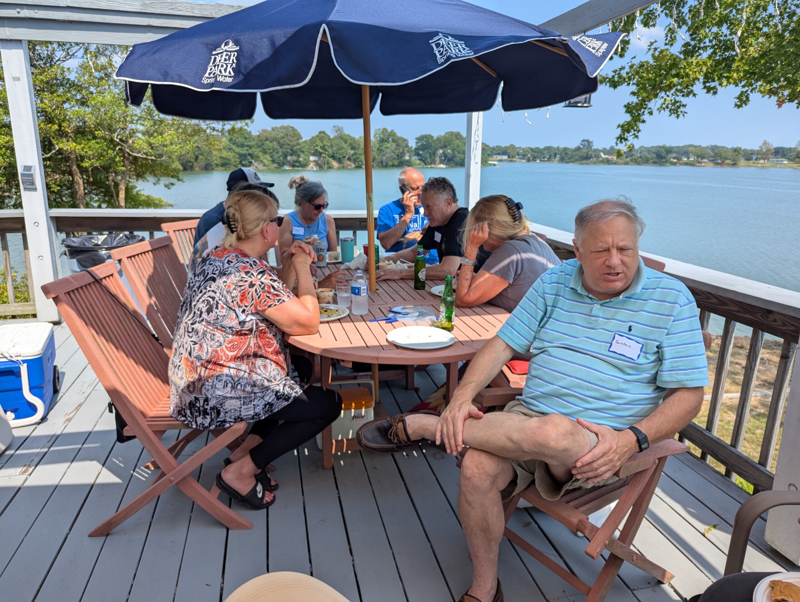 People gathered around a table on deck.